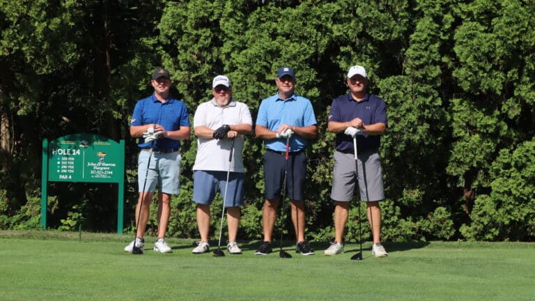 Four golfers in a line.