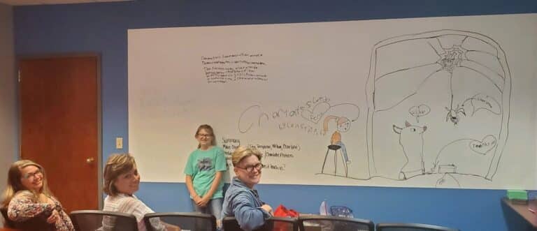 Randolph County student Constance Breedlove teaches the lessons she learned reading “Charlotte’s Web” to Heart of Indiana United Way team members Denise King, Laura Vise, and C.S. Hendershot.